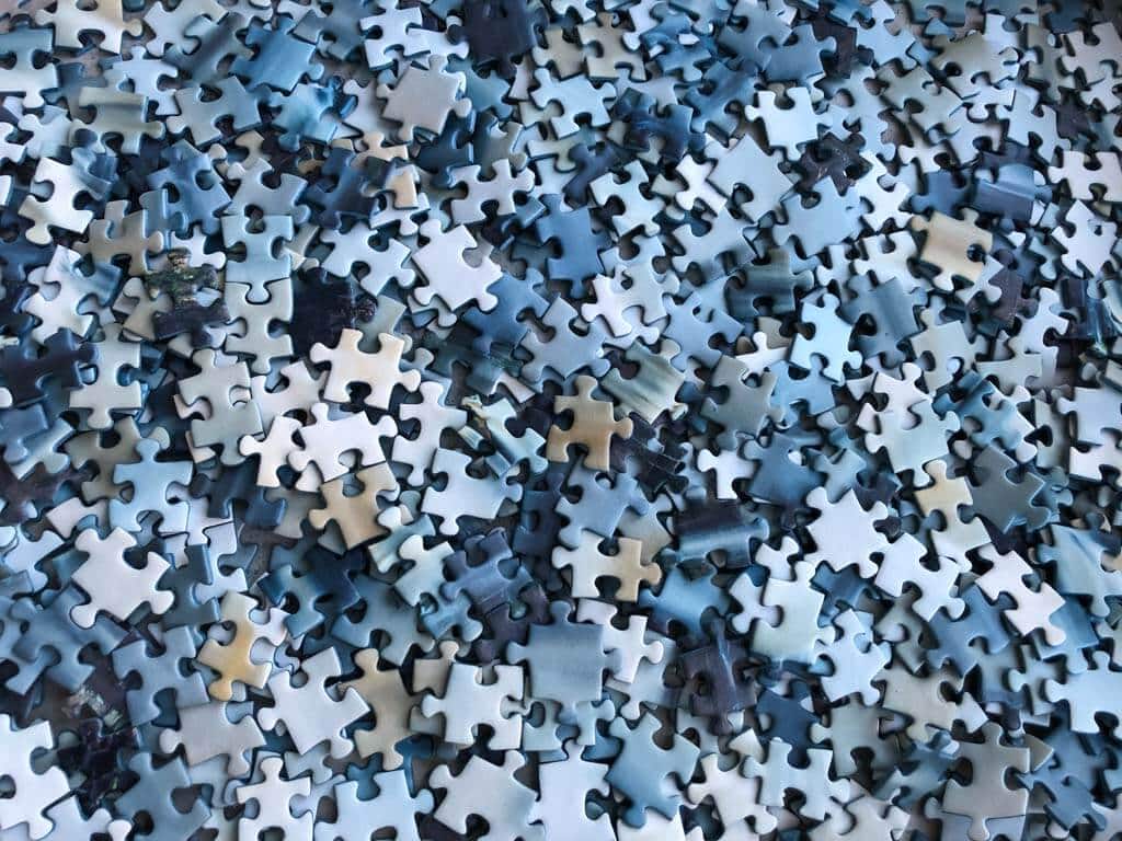 A box full of jigsaw puzzle pieces