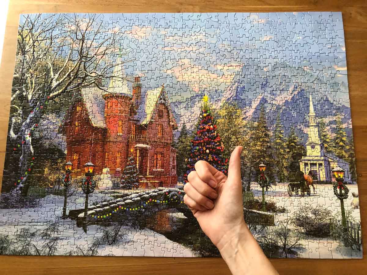 Photo of a finished Christmas puzzle with a thumb up