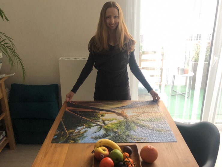 Veronika of Jigsaw Puzzle Queen posing with a finished beach puzzle